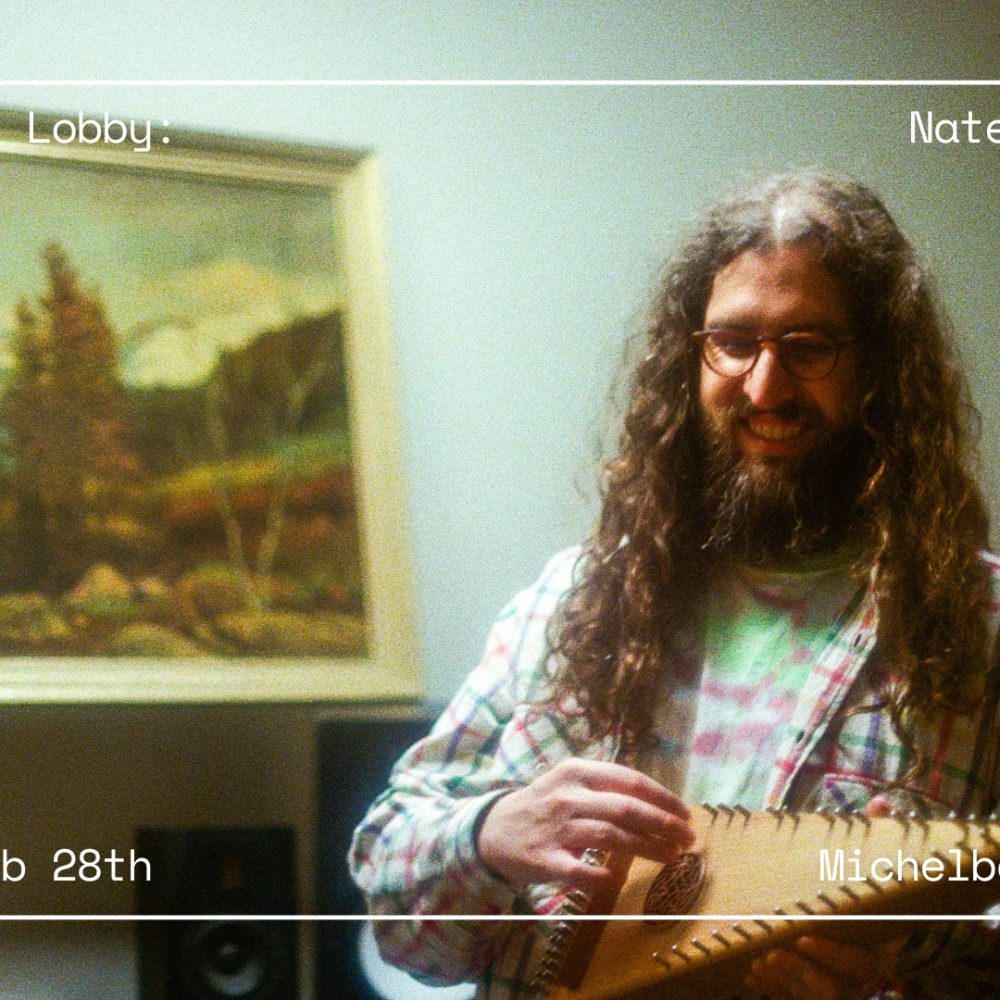 Guitarist Nate Mercereau holds a historic guitar while playing a gig in a museum